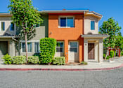 Thumbnail 6 of 20 - an orange and green house with a street in front of it
