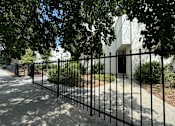 Thumbnail 19 of 44 - a black iron fence in front of a building