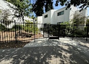 Thumbnail 20 of 44 - an image of an apartment building behind a fence
