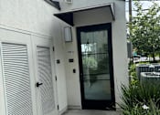 Thumbnail 38 of 44 - the front entrance of a laundry room with a glass door