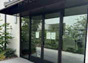 Thumbnail 41 of 44 - the entrance to a gym room with glass doors