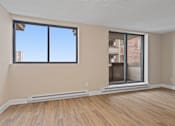 Thumbnail 19 of 20 - A room with a large window and a sliding glass door.