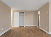 Thumbnail 18 of 20 - A room with a white door and a white fridge.
