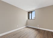 Thumbnail 17 of 20 - A room with a window and wooden flooring.