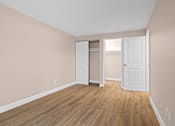 Thumbnail 16 of 20 - A room with a white door and a white closet with a white door.