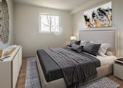 Thumbnail 8 of 10 - A bedroom with a large bed and a painting on the wall.