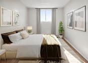 Thumbnail 4 of 9 - A bedroom with a large bed and a potted plant.