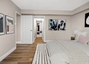 Thumbnail 20 of 24 - A bedroom with a large bed and artwork on the wall.
