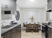 Thumbnail 15 of 34 - A modern kitchen with a dining table set for four.