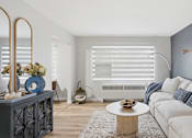Thumbnail 8 of 34 - A modern living room with a white sofa and a coffee table.