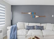 Thumbnail 4 of 34 - A white couch with a blue throw blanket on it.