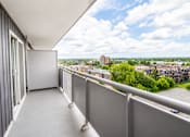 Thumbnail 12 of 17 - A balcony with a view of a cityscape.