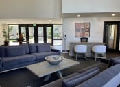 Thumbnail 5 of 22 - a common room with couches and chairs and a table with a bowl of rocks on it