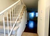 Thumbnail 20 of 29 - the hallway of a house with stairs and a carpeted floor