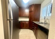 Thumbnail 21 of 29 - a kitchen with stainless steel appliances and wooden cabinets