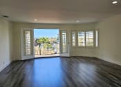 Thumbnail 44 of 52 - an empty living room with windows and a balcony