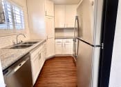 Thumbnail 18 of 29 - a kitchen with stainless steel appliances and white cabinets