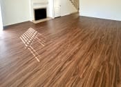 Thumbnail 24 of 29 - an empty living room with wood flooring and a fireplace
