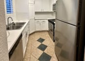 Thumbnail 27 of 29 - a kitchen with stainless steel appliances and white cabinets