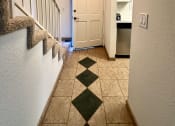 Thumbnail 26 of 29 - a hallway with stairs and a door to a kitchen