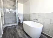 Thumbnail 52 of 52 - a white bathroom with a large tub and a shower