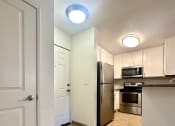 Thumbnail 7 of 29 - a kitchen with stainless steel appliances and white cabinets