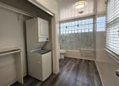 Thumbnail 35 of 52 - a small bathroom with a washer and dryer in it