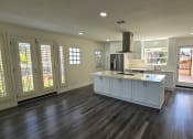 Thumbnail 37 of 52 - a kitchen with white cabinets and a large island