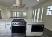 Thumbnail 51 of 52 - a large white kitchen with an island and stainless steel appliances
