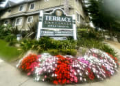 Thumbnail 1 of 29 - a building with a sign in front of a palm tree