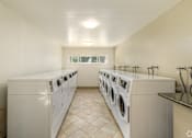 Thumbnail 20 of 22 - a washer and dryer laundry room with two sets of washing machines