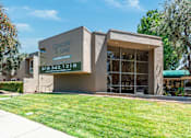 Thumbnail 1 of 22 - a building with a lawn in front of it