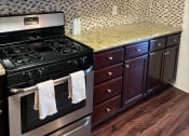 Thumbnail 6 of 30 - a kitchen with a stove and microwave
