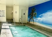 Thumbnail 10 of 29 - a large swimming pool in a building with a palm tree