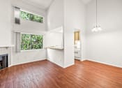 Thumbnail 10 of 16 - an empty living room with wood floors and a fireplace