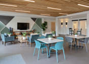 Thumbnail 5 of 17 - a large room with tables and chairs and a tv