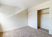 Thumbnail 2 of 15 - A room with a carpeted floor and a window on the left side.