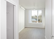 Thumbnail 15 of 17 - a living room with a window and a door