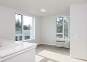 Thumbnail 13 of 17 - an empty kitchen with a radiator and large windows