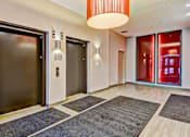 Thumbnail 69 of 72 - A hallway with a red light and a black door.