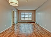 Thumbnail 57 of 72 - A room with wooden floors and a large window.