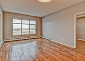 Thumbnail 56 of 72 - A room with wooden flooring and a large window.