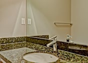 Thumbnail 49 of 72 - A bathroom with a marble counter top and a round sink.