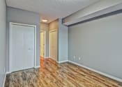 Thumbnail 48 of 72 - A room with wooden floors and white walls.