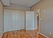 Thumbnail 43 of 72 - A room with a white door and a brown floor.
