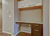 Thumbnail 33 of 72 - A corner desk with drawers and cabinets in a room.