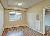 Thumbnail 30 of 72 - A room with a window and a white electrical box on the wall.