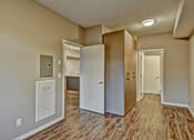 Thumbnail 29 of 72 - A room with a white door, a brown door, and a white cabinet.