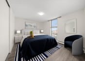 Thumbnail 4 of 33 - a bedroom with a large bed and a chair