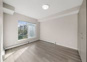 Thumbnail 9 of 72 - an empty room with wood floors and a window